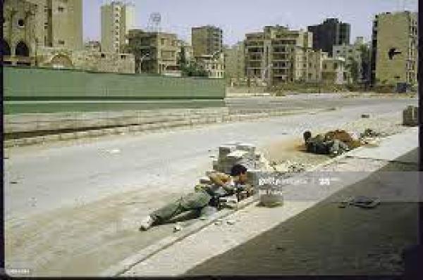 Druse Progressive Socialist Party militiamen take cover from sniper fire at Barbir section of museum Green Line crossing between West and East Beirut, during internecine fighting. Photo by Bill Foley/The LIFE Images Collection, May 1, 1985.                                                                                                                                                                                                                                       