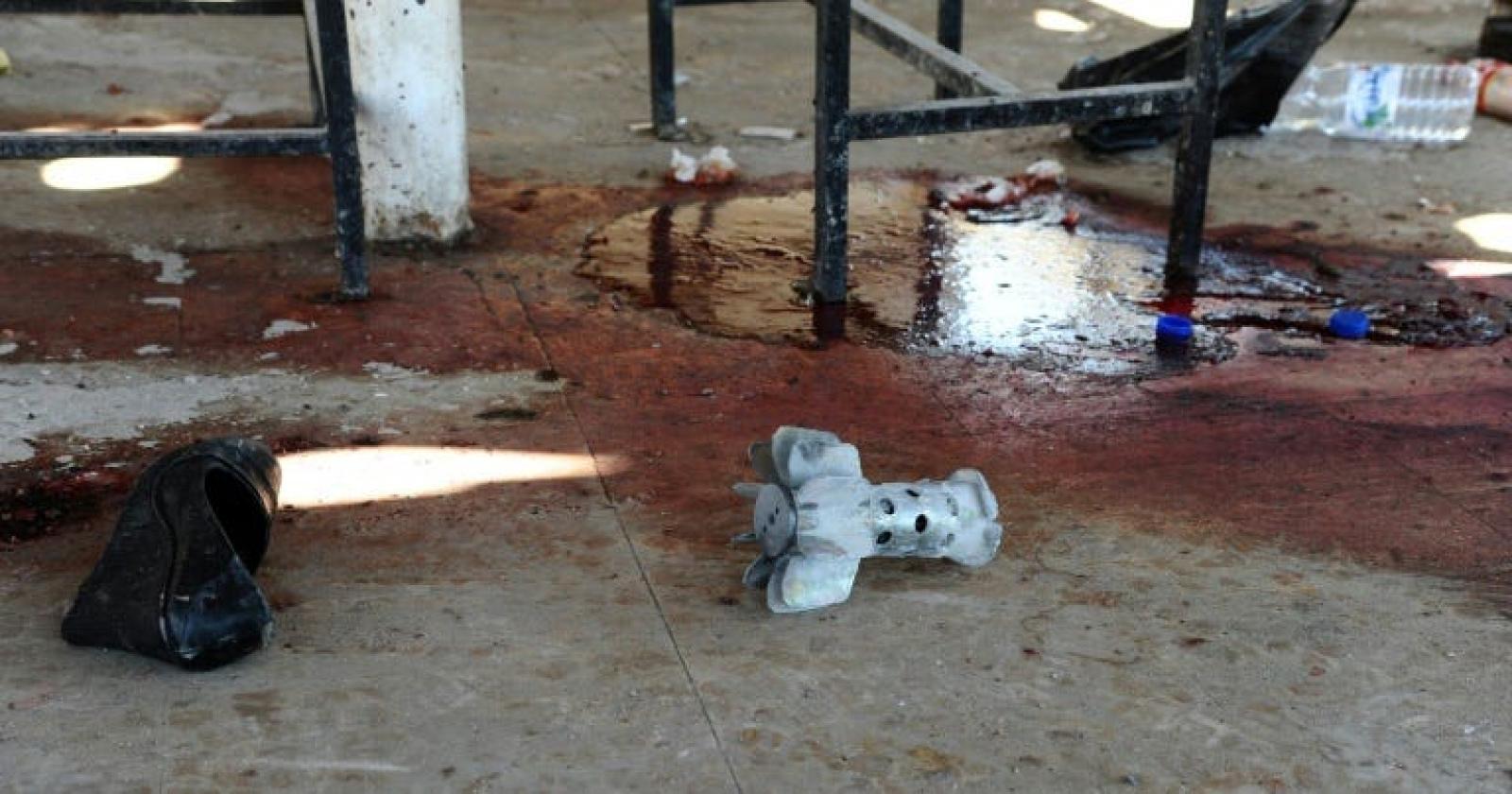 A pool of blood and the remains of a projectile following an alleged rebel rocket attack outside Syria's Adra prison