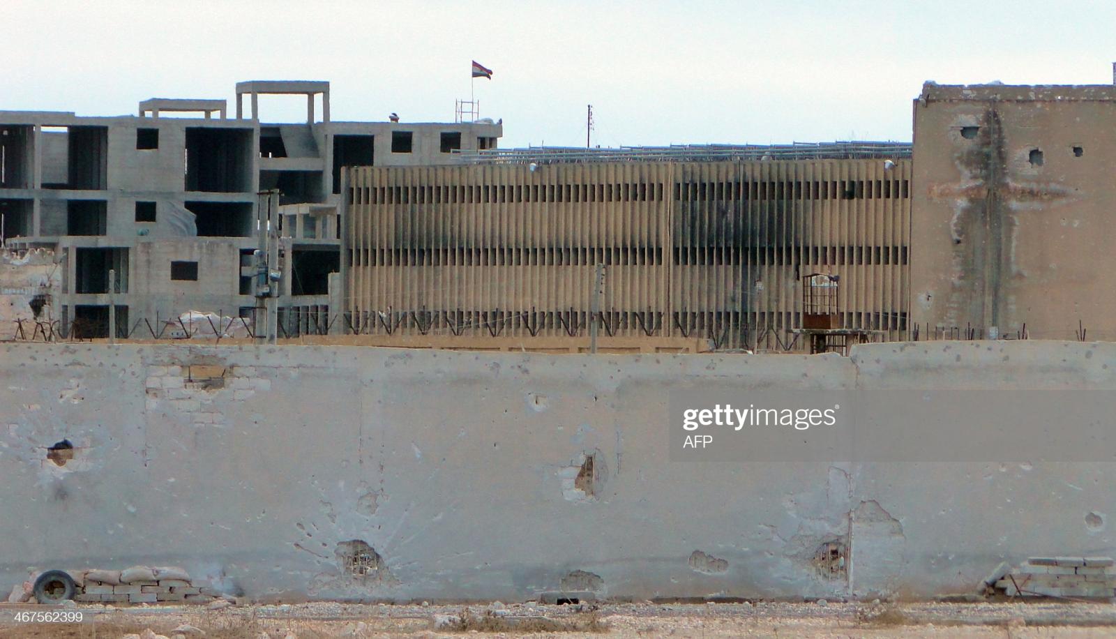 A picture taken on February 6, 2014, shows the Aleppo central prison during clashes between pro-Syrian regime soldiers and rebel fighters. Syrian troops retook most of Aleppo's prison, lost to rebels a day earlier, in fighting that has killed at least 46 people over two days, the Syrian Observatory for Human Rights said. AFP PHOTO/AMC/ZEIN AL-RIFAI